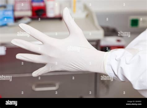 Doctor Puts On Latex Gloves Stock Photo Alamy