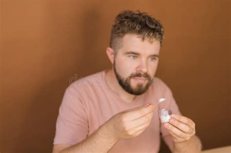 Famous Blogger Cheerful Male Vlogger Showing Cosmetics Products While