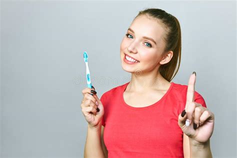 Young Beautiful Woman Is Engaged In Cleaning Teeth Beautiful Smile