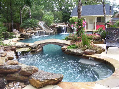 This pool combines size with a very attractive design that looks good from all angles. Natural mossrock waterfall pool with slide, beach entry ...