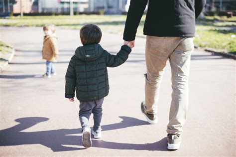 Padre Caminando Con Su Hijo En La Calle Foto Gratis