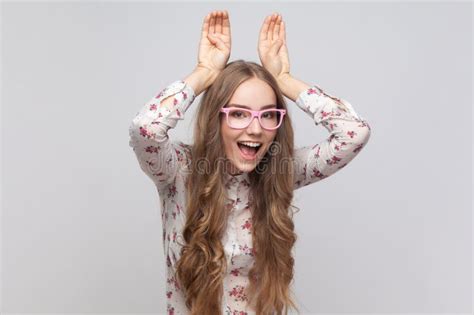 Funny Woman In Glasses Showing Bunny Ears Gesture Looking At Camera