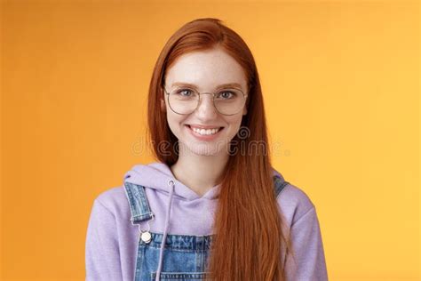 good looking redhead female programmer glasses hoodie smiling satisfied look professional aim