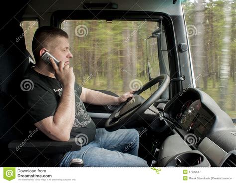 truck driver driving  talking  phone editorial photography image