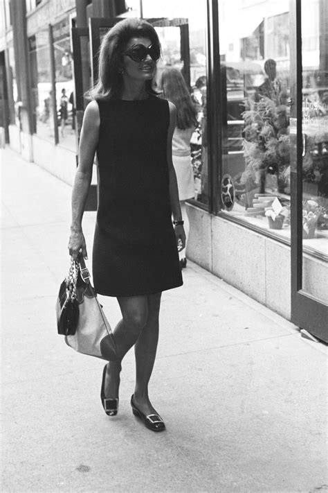 Jacqueline Kennedy Onassis Wearing A Black Dress Sunglasses And The