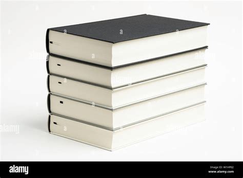 A Set Of Five Neatly Stacked And Arranged Monochromatic Cloth Bound Books On A Plain White