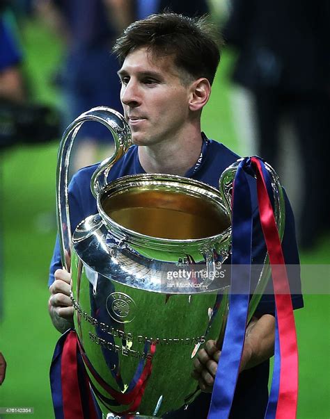 Lionel Messi Of Barcelona Holds The Trophy During The Uefa Champions