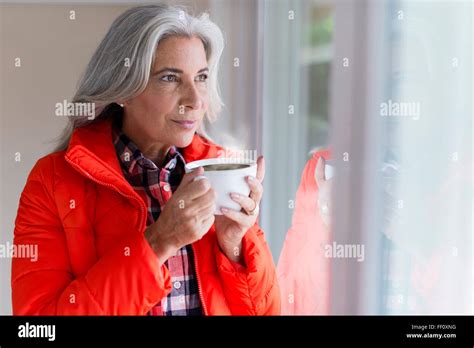 Caucasian Woman Drinking Coffee In Window Stock Photo Alamy