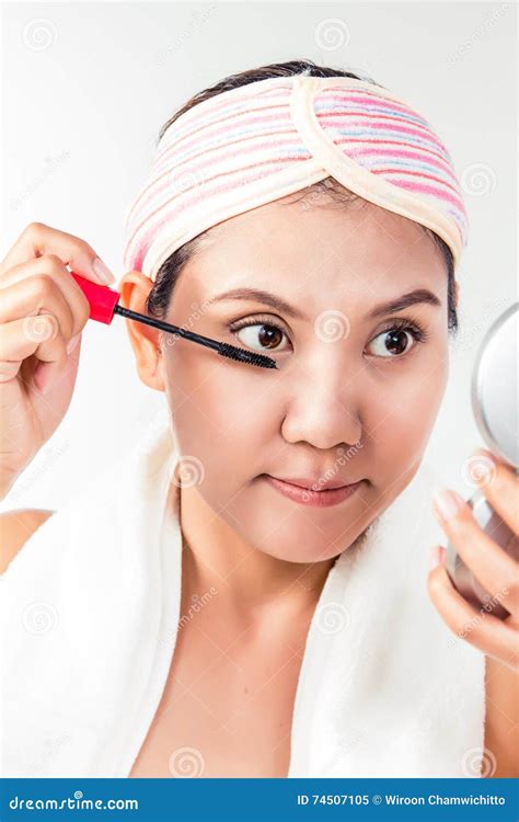Asian Woman Applying Mascara Makeup On Eyes By Brush Stock Image