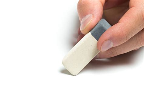 Mens Hand Holding Eraser On Isolated Backgroung Close Up Stock Photo