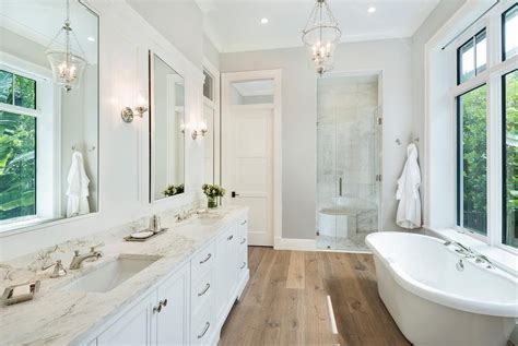 Rustic Wide Plank Wood Floors With White Bath Vanity Cabinets