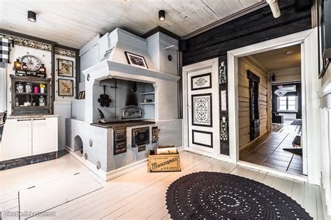The Kitchen Is Decorated In Black And White With Lots Of Woodwork On