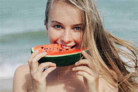Woman Eating Watermelon On Beach Stock Photo Dissolve