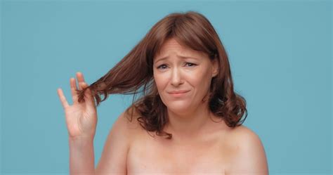 Premium Photo Unhappy Beautiful Woman Holds Of Hair Ends Looking At