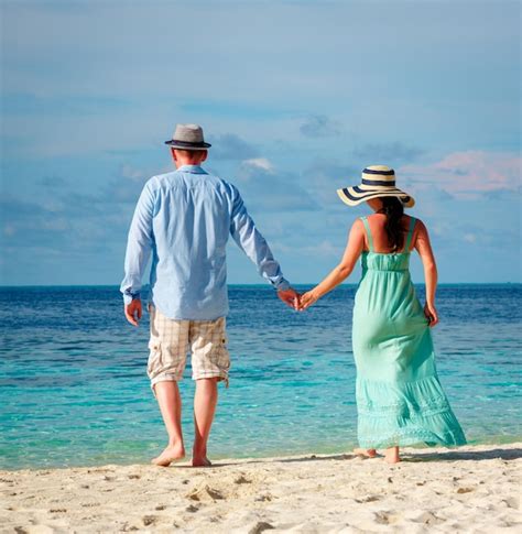 premium photo couple on vacation walking on a tropical beach maldives man and woman romantic
