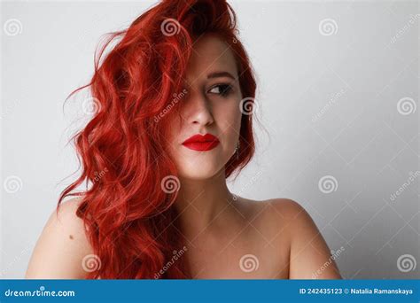 Stunning Young Woman With Long Red Hair Looks Aside Posing On White Background Stock Image