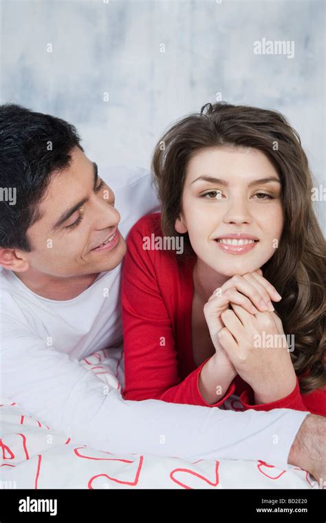 Couple Cuddling In Bed Stock Photo Alamy
