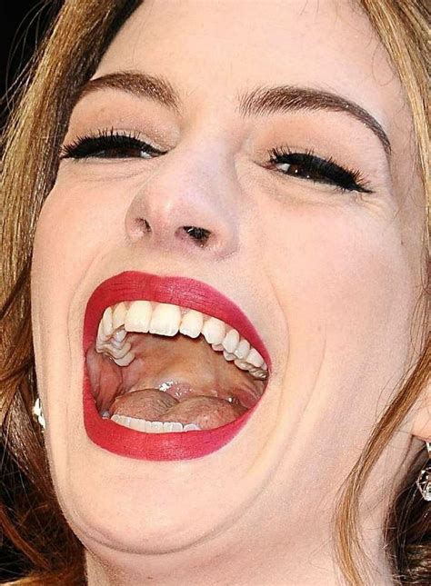 A Close Up Of A Woman With Her Mouth Open And Tongue Hanging Out To The
