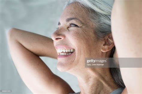 Beautiful Mature Woman With Hands Behind Head Photo Getty Images