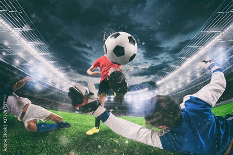 Close Up Of A Football Action Scene With Competing Soccer Players At