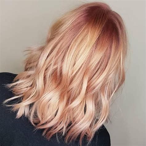 We love how it fades out in a reverse. Back of woman's head showing wavy, peach and pink hair ...