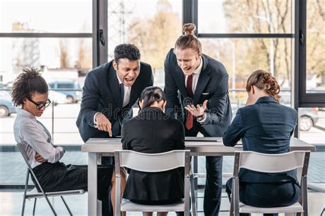 Young Emotional Businesspeople In Formalwear Arguing At Meeting In