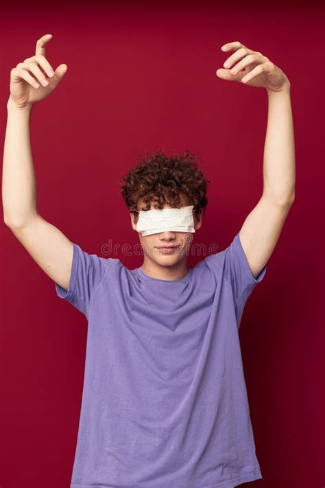 kinky guy in purple t shirts medical mask in hands safety isolated background unaltered stock