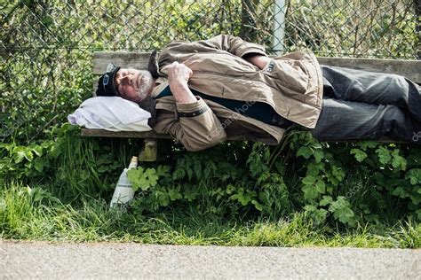 Homeless Man Sleeping On Bench Stock Photo Ysbrand