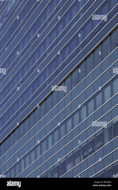 The Side Of A Building Covered With Reflective Glass Windows Stock