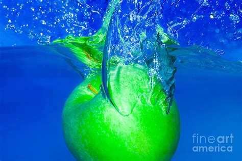 Splash Green Apple With Blue Background Photograph By Kristian Peetz
