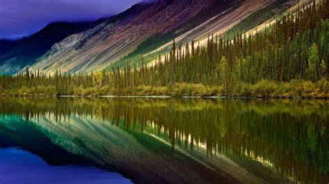 Landscape Of Colorful Mountains And Body Of Water With Reflection Of