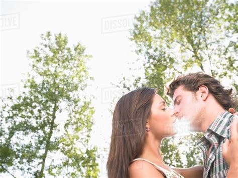 Couple Kissing Under Trees Stock Photo Dissolve