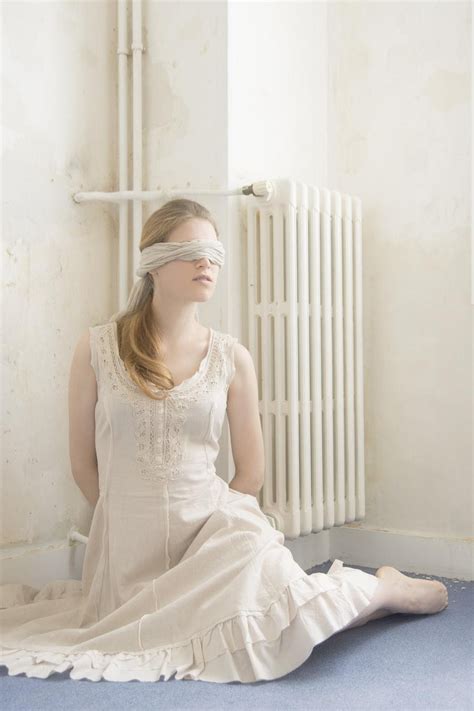 Women Model Women Indoors Blindfold Bound On The Floor Radiator