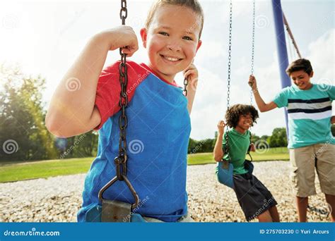 Wanna See My Swinging Skills Portrait Of A Young Boy Playing On A