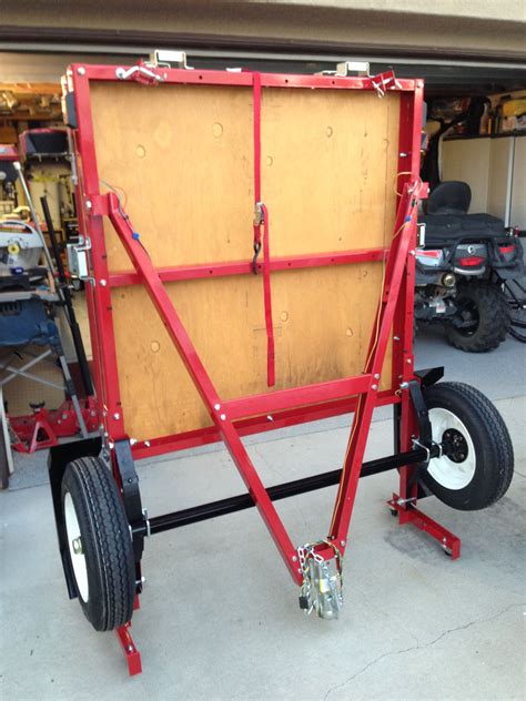 Ball hitch to transport securely. Folding trailer in folded position, ready for storage ...
