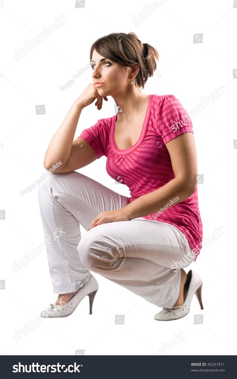Thoughtful Pretty Woman In The Squatting Position Isolated Stock Photo