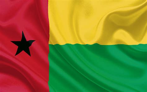 The flag has equal horizontal stripes of yellow over green, with a red vertical stripe at the hoist bearing a black star. Guiné-Bissau | Unilab