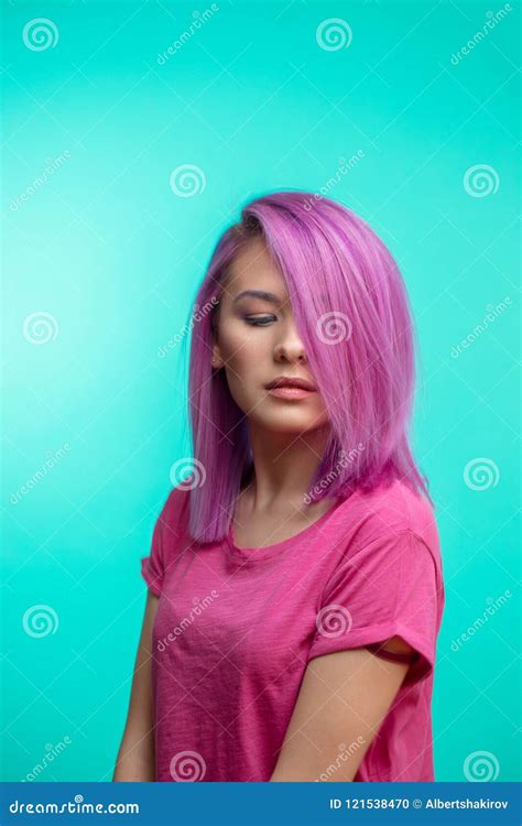 Attractive Girl With Pink Hair Dressed In Casual Pink Cloth On Blue