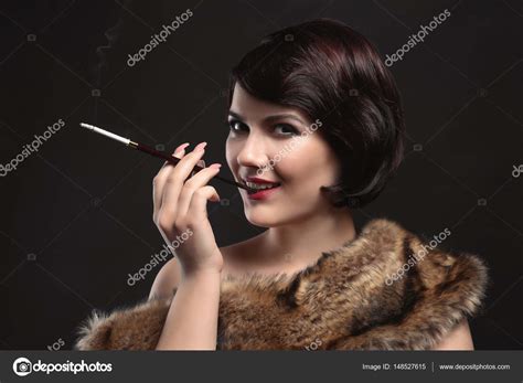 Woman Smoking With Cigarette Holder Stock Photo By ©belchonock 148527615