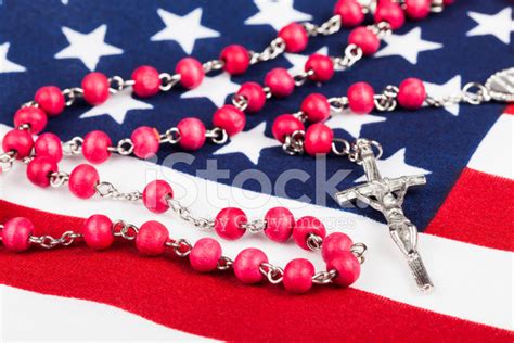 Catholic Rosary On American Flag Stock Photos
