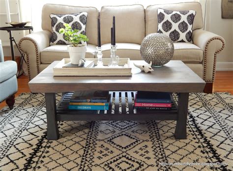 This piece is crafted from solid poplar wood and oak and birch veneers, and it features rounded pilasters with turned details that contribute to its traditional feel. Number Fifty-Three: Weathered Gray Coffee Table