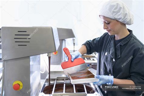 Chocolatier Filling Chocolate Molds In Chocolate Factory Proplr