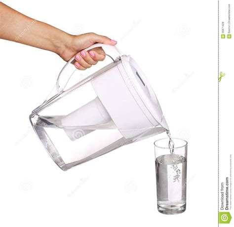 Hand Holding Water Filter Jug And Pouring Water Into A Glass Stock