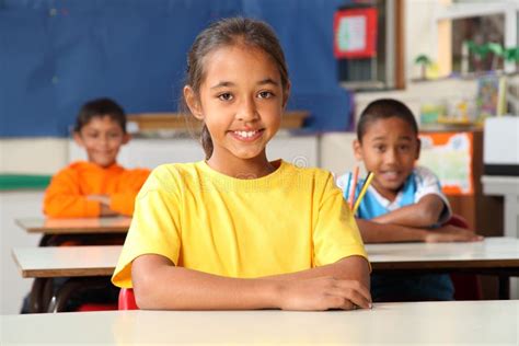 Primary School Children Sitting To Desks In Class Stock Image Image