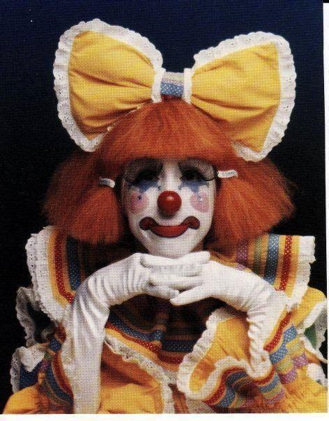 A Clown With Red Hair And White Makeup