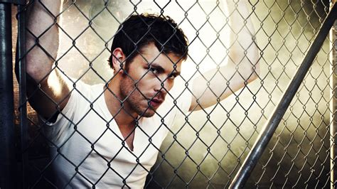 Damon Salvatore In White T Shirt Near Chain Link Fence Hd