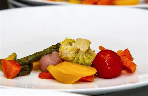 Beautifully Laid Out French Steamed Vegetables On A White Plate Close