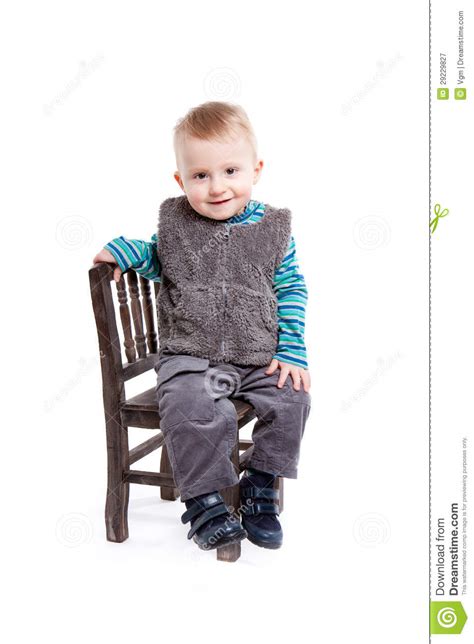 Cute baby boy toddler sitting and holding hand stock photo. Baby Boy Sitting On A Chair Royalty Free Stock Photography ...