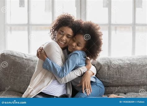 Loving African American Mom And Daughter Hugging Cuddling Stock Image