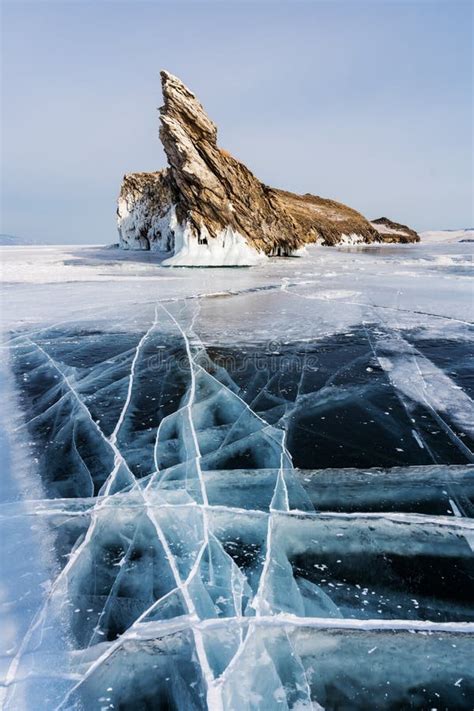 Winter Landscape Cracked Ground Of Frozen Lake Baikal With Beautiful